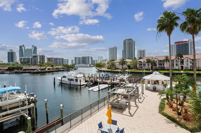 view of dock featuring a gazebo, a water view, and a view of city
