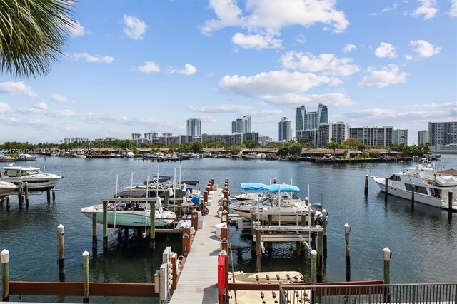 dock area featuring a city view, boat lift, and a water view