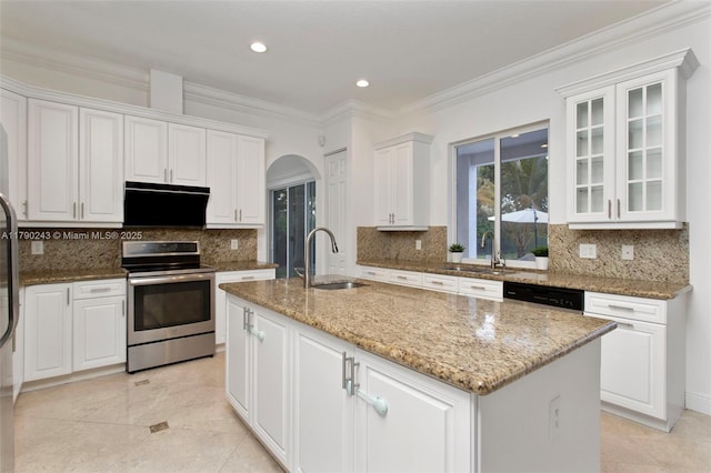 15355 SW 34th St, Davie, FL 33331 - kitchen featuring appliances with stainless steel finishes, arched walkways, white cabinetry, a kitchen island with sink, and light stone counters