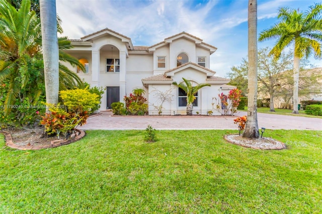 15355 SW 34th St, Davie, FL 33331 - mediterranean / spanish home with stucco siding, a front lawn, and a tile roof