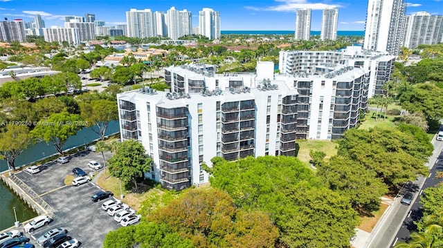 birds eye view of property with a water view and a city view