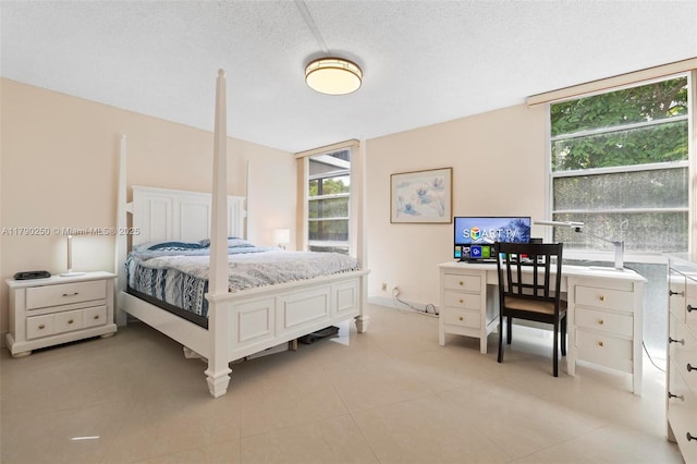 bedroom with light tile patterned floors and a textured ceiling