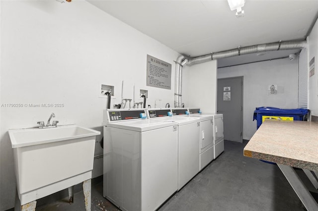 community laundry room featuring washer and dryer and a sink