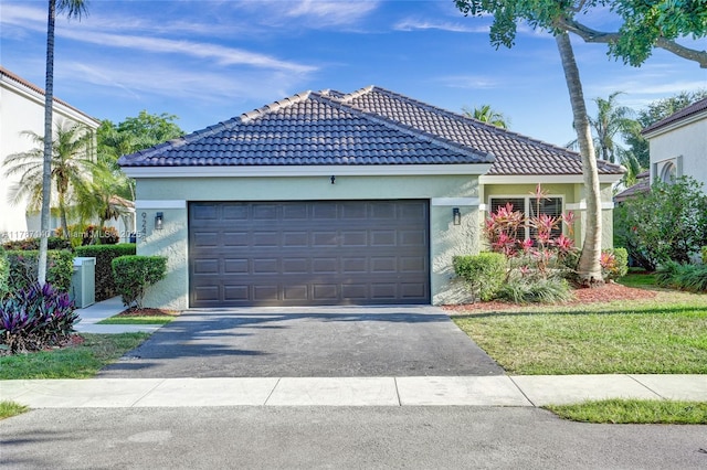 9248 Magnolia Ct, Davie, FL 33328 - ranch-style home with driveway, a tiled roof, stucco siding, and a garage