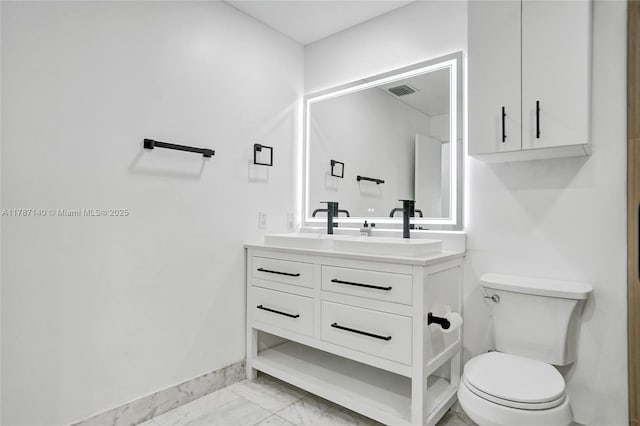 9248 Magnolia Ct, Davie, FL 33328 - bathroom featuring marble look tiles, toilet, vanity, and baseboards