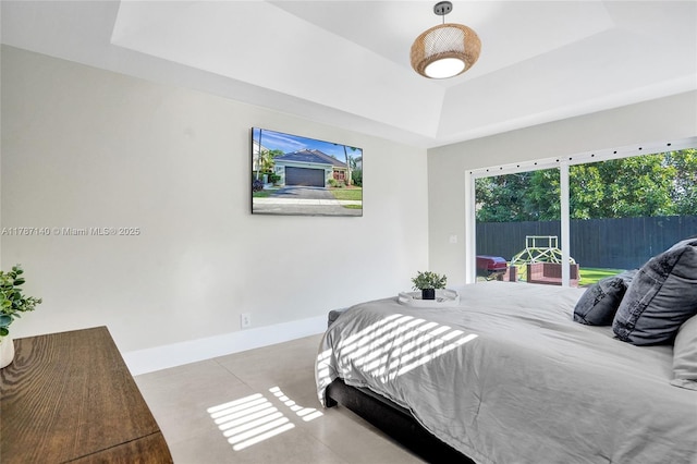 9248 Magnolia Ct, Davie, FL 33328 - bedroom featuring a raised ceiling, access to outside, baseboards, and finished concrete floors