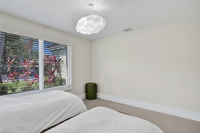 9248 Magnolia Ct, Davie, FL 33328 - bedroom featuring light tile patterned flooring, a chandelier, and baseboards