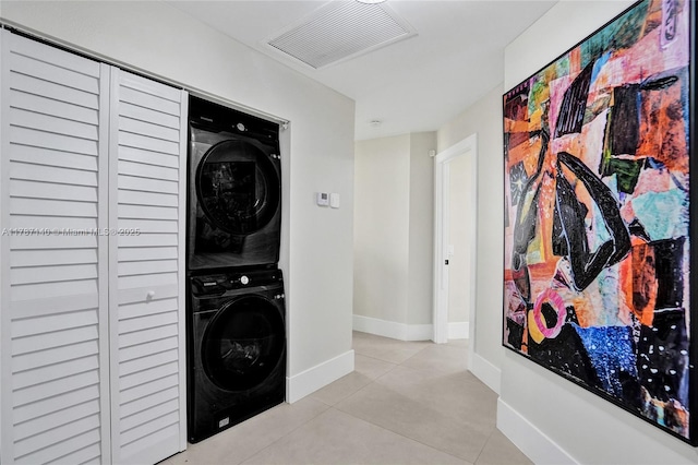 9248 Magnolia Ct, Davie, FL 33328 - washroom with stacked washing machine and dryer, light tile patterned floors, and baseboards