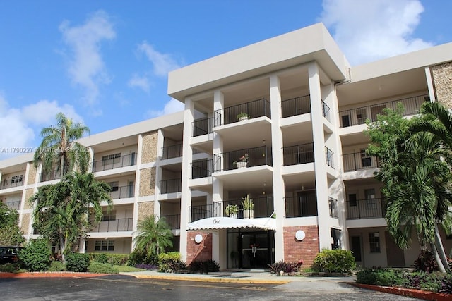 view of building exterior with uncovered parking