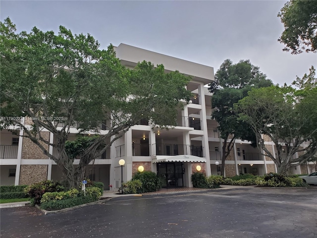 view of building exterior featuring uncovered parking