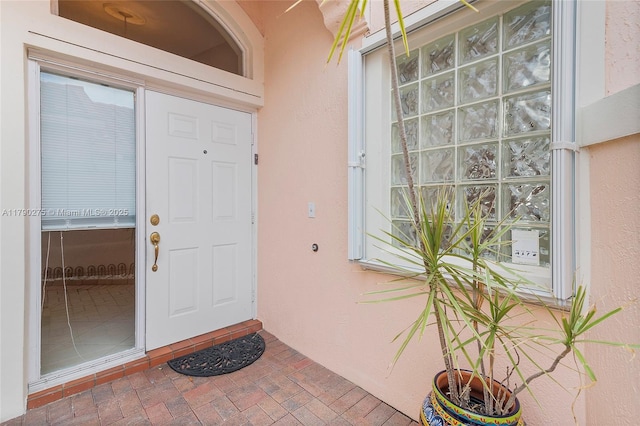 entrance to property with stucco siding