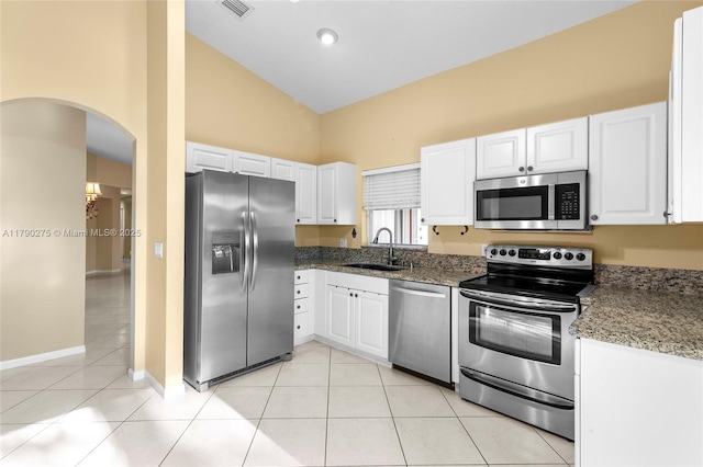 kitchen featuring white cabinetry, high vaulted ceiling, appliances with stainless steel finishes, and a sink