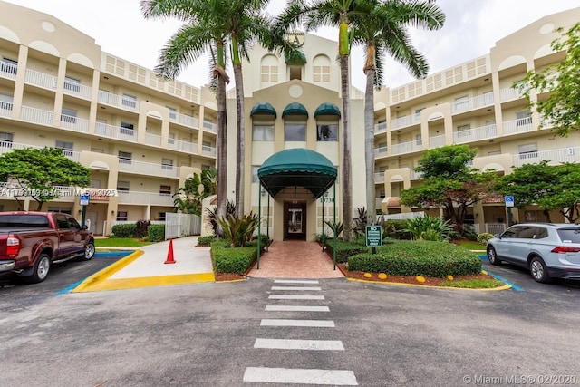 10730 NW 66 Unit 101, Doral, FL 33178 - view of apartment building / complex featuring uncovered parking