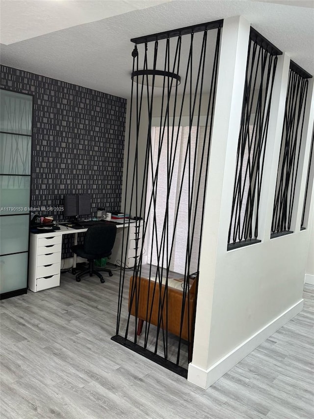 10730 NW 66 Unit 101, Doral, FL 33178 - home office featuring light wood finished floors, a textured ceiling, and baseboards