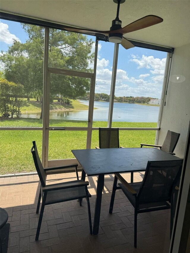 10730 NW 66 Unit 101, Doral, FL 33178 - sunroom / solarium featuring a water view, ceiling fan, outdoor dining area, and healthy amount of natural light