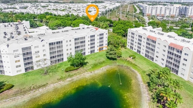 10730 NW 66 Unit 101, Doral, FL 33178 - drone / aerial view of a nearby body of water and apartment complex / building