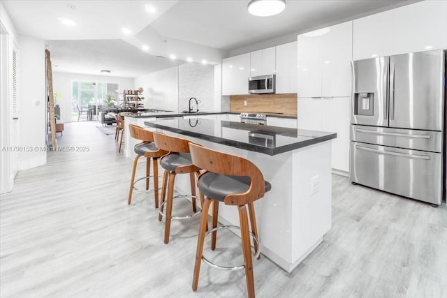 10730 NW 66 Unit 101, Doral, FL 33178 - kitchen with appliances with stainless steel finishes, a sink, modern cabinets, a breakfast bar area, and recessed lighting