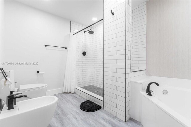 10730 NW 66 Unit 101, Doral, FL 33178 - full bathroom with a shower stall, a garden tub, wood finished floors, toilet, and a bidet