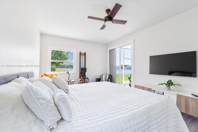 10730 NW 66 Unit 101, Doral, FL 33178 - bedroom with access to outside, multiple windows, wood finished floors, and ceiling fan
