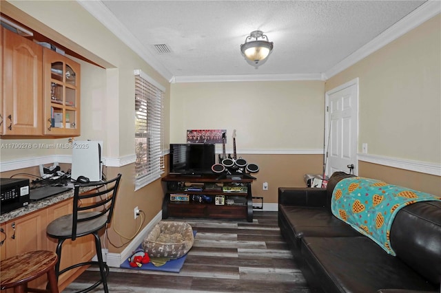 living room with crown molding, a textured ceiling, baseboards, and dark wood finished floors