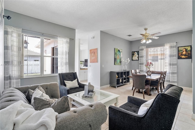 13995 S Cypress Cove Cir, Davie, FL 33325 - living room with light tile patterned floors, a textured ceiling, and a ceiling fan