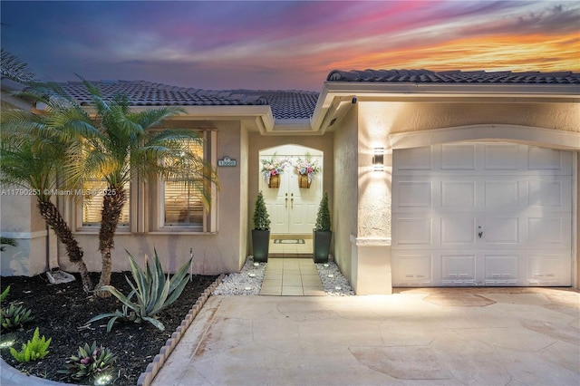 13995 S Cypress Cove Cir, Davie, FL 33325 - entrance to property featuring stucco siding, a tiled roof, driveway, and a garage