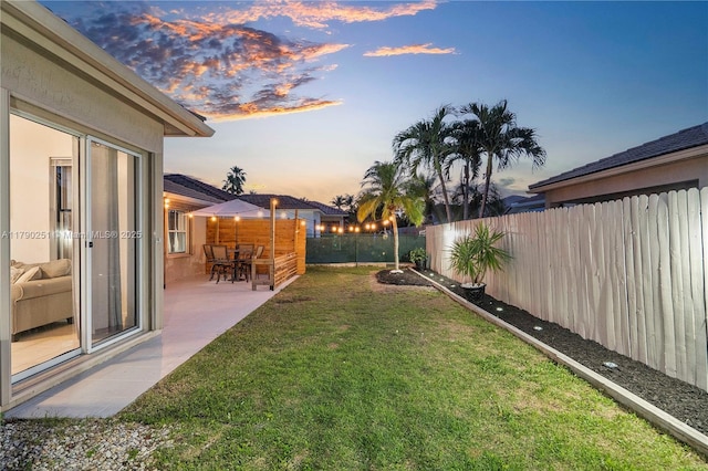 13995 S Cypress Cove Cir, Davie, FL 33325 - yard at dusk with a fenced backyard and a patio