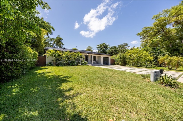 288 NE 117th St, Miami, FL 33161 - view of yard featuring driveway and an attached garage