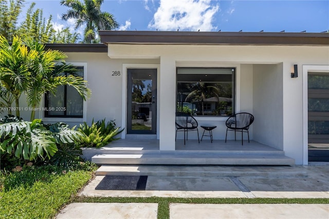 288 NE 117th St, Miami, FL 33161 - view of exterior entry featuring stucco siding and a porch