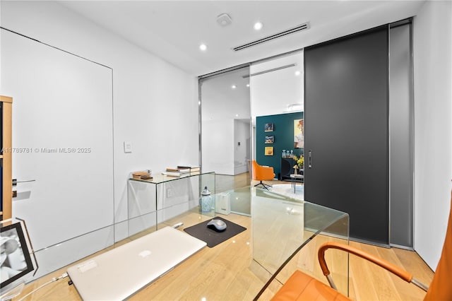 office with visible vents, wood finished floors, and recessed lighting
