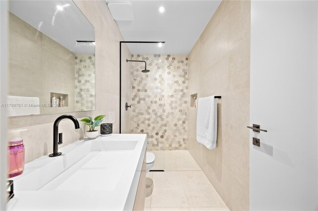 288 NE 117th St, Miami, FL 33161 - bathroom with tile walls, a tile shower, vanity, tile patterned flooring, and recessed lighting