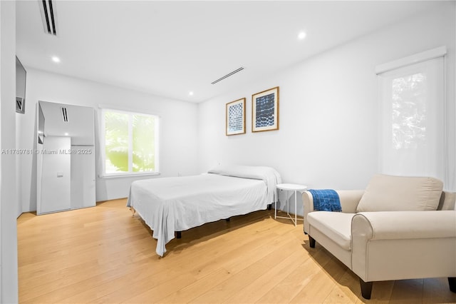 bedroom with visible vents, recessed lighting, and light wood-type flooring