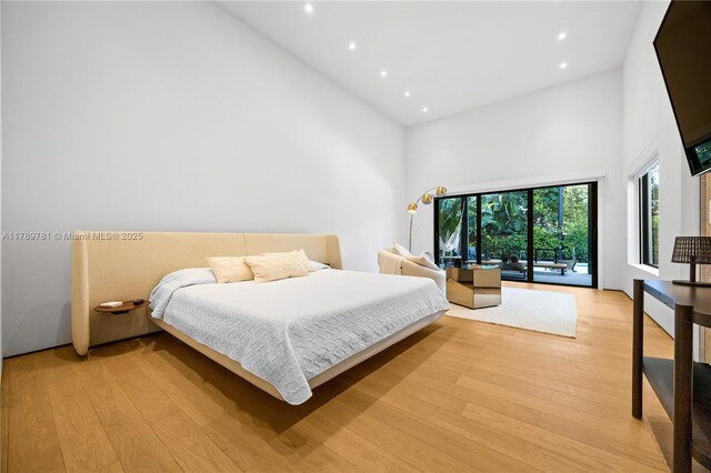 288 NE 117th St, Miami, FL 33161 - bedroom with high vaulted ceiling, access to outside, light wood-type flooring, and recessed lighting