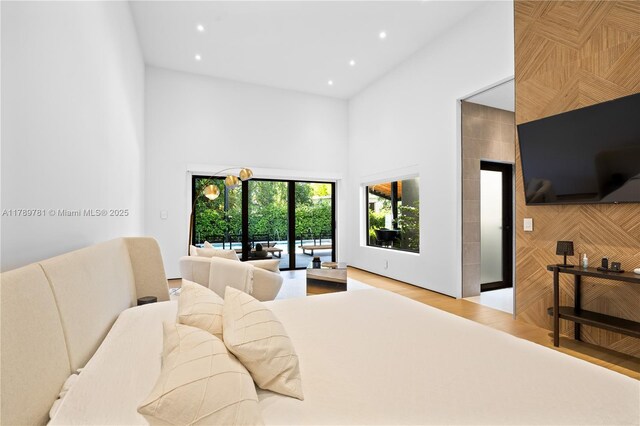 288 NE 117th St, Miami, FL 33161 - bedroom featuring a high ceiling, access to outside, recessed lighting, and wood finished floors