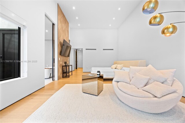 288 NE 117th St, Miami, FL 33161 - living room with light wood-style flooring, a towering ceiling, and recessed lighting