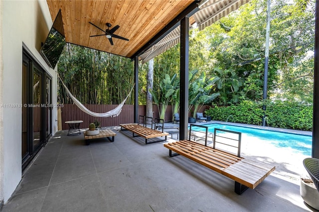view of patio / terrace featuring fence, ceiling fan, and a fenced in pool