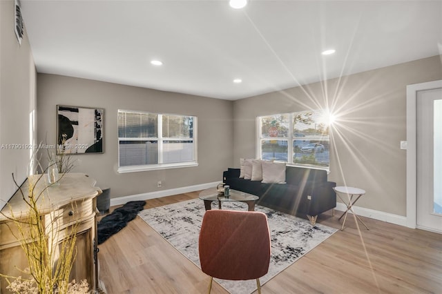 living area with wood finished floors, baseboards, and recessed lighting