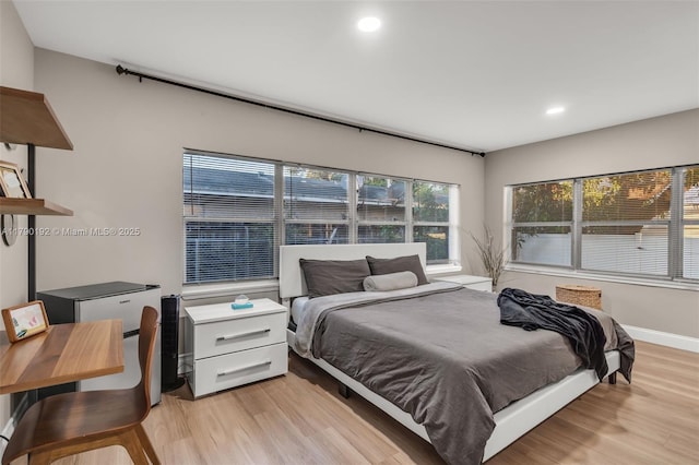 bedroom featuring recessed lighting, light wood-type flooring, and baseboards