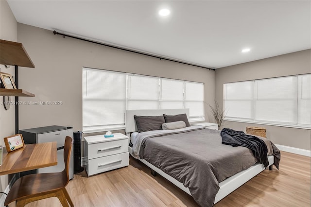 bedroom with light wood-type flooring, baseboards, and recessed lighting