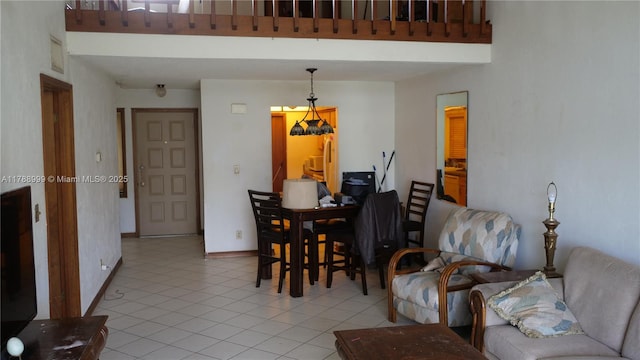 living area featuring baseboards and light tile patterned floors