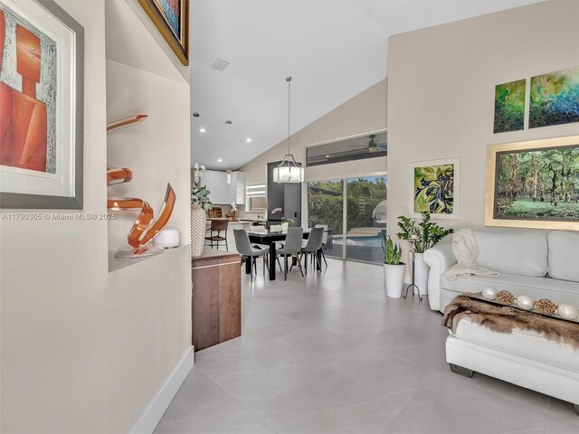 living room with baseboards, visible vents, a chandelier, recessed lighting, and high vaulted ceiling