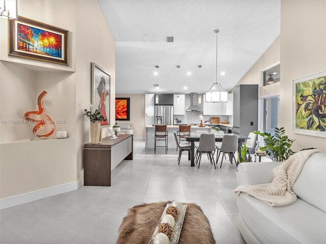 living room featuring baseboards, recessed lighting, visible vents, lofted ceiling, and light tile patterned floors