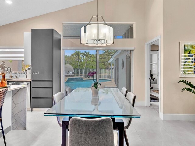 dining room with recessed lighting, high vaulted ceiling, baseboards, and a notable chandelier