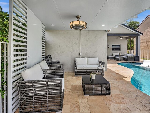 view of patio featuring fence, an outdoor pool, an outdoor hangout area, and ceiling fan