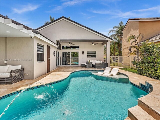 view of swimming pool with outdoor lounge area, fence, a fenced in pool, and ceiling fan
