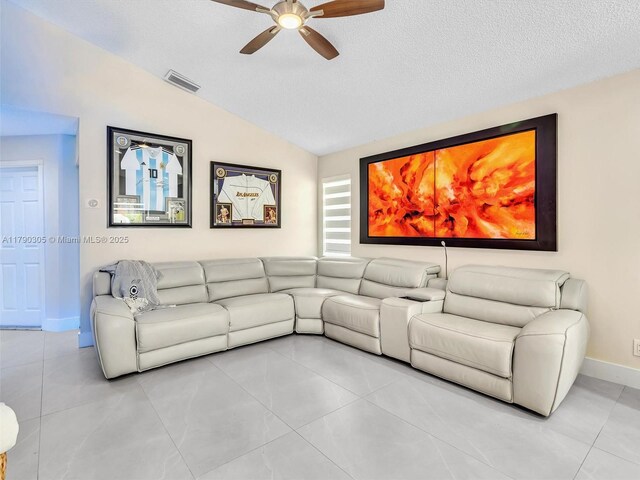 living area featuring lofted ceiling, visible vents, ceiling fan, and light tile patterned floors