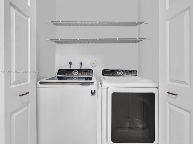 laundry room featuring washing machine and clothes dryer and laundry area