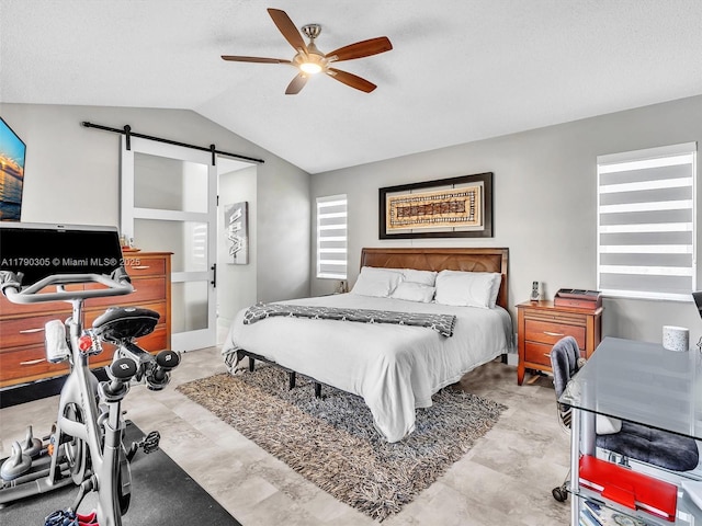 bedroom with vaulted ceiling, a ceiling fan, and a barn door