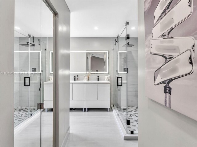 bathroom with recessed lighting, vanity, and a stall shower