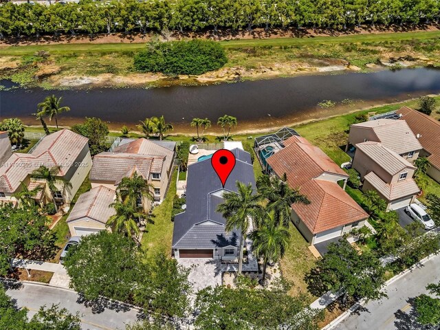 birds eye view of property with a residential view and a water view